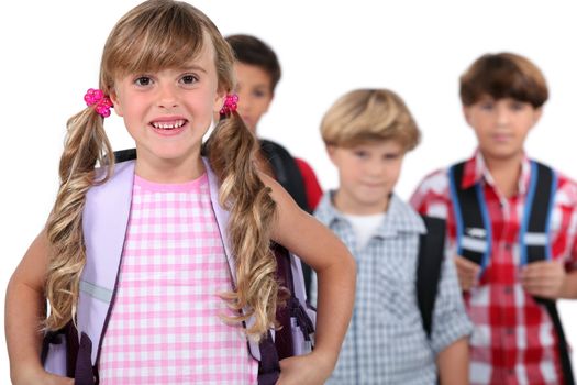 Four young children with backpacks