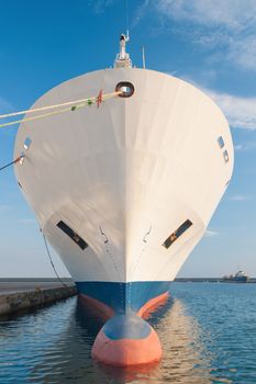Bulbous bow of dry cargo ship docked in harbor
