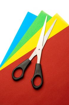 Colored papper and scissors isolated on white