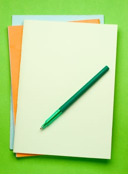 Notepads isolated on the green background