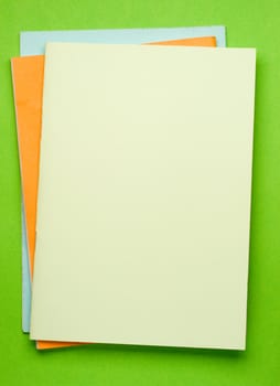 Notepads isolated on the green background