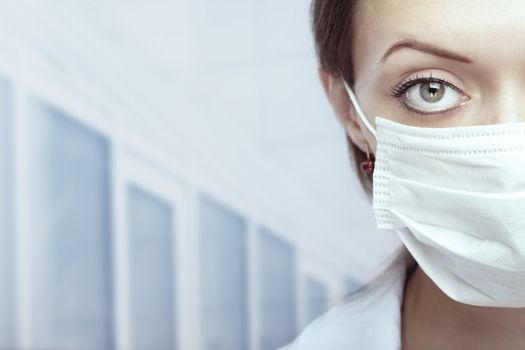Close-up portrait of the doctor in the clinic with protective mask 