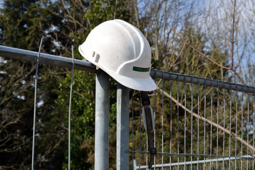 Construction hard hat on Fence