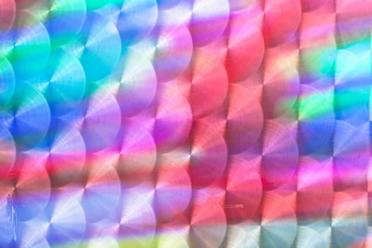 Colorful light reflected in a textured metal surface