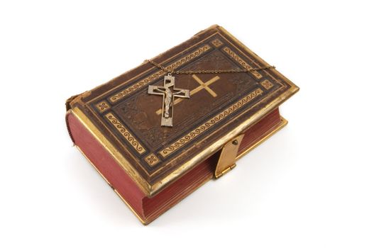 Cross on a religious book, isolated on a white background