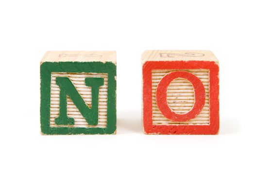 Children's wooden blocks saying "NO" isloated on a white background