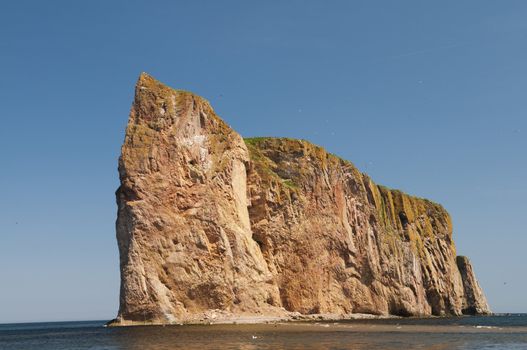Looking up at the Perce Rock famous landmark located on the Gaspe Peninsula, Quebec, Canada