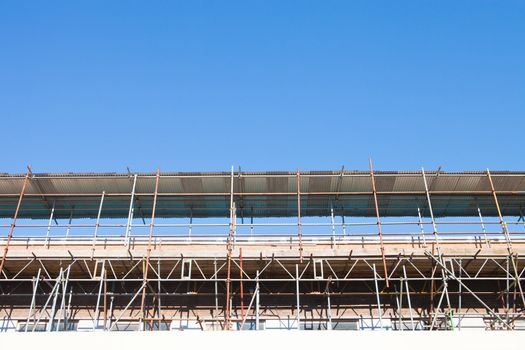 Scaffolding at a construction site in the UK on a sunny day