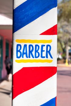 Close up of a colorful sign for a barber shop