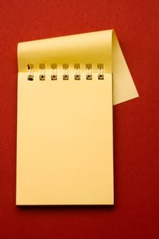 Notepad isolated on the red background