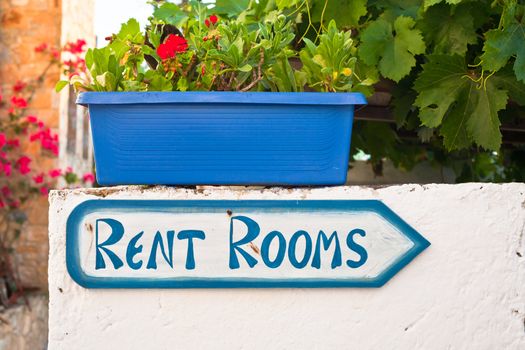 Sign for holiday accommodation in a Greek village