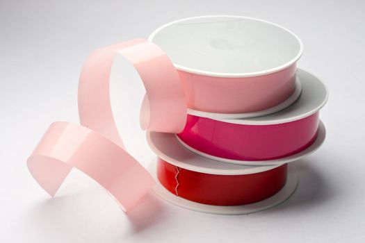 Reels of ribbon isolated on the grey background