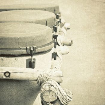 Monochrome image of three old african bongo drums