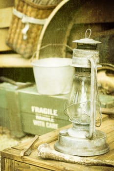 A vintage glass oil lamp on an old wooden crate