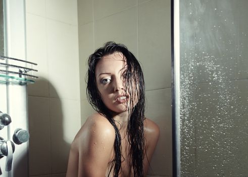 Wet woman in the shower cabin