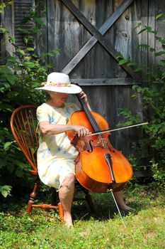 Female cellist performing outdoors.