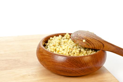 Bowl of fresh cous cous salad on a white background