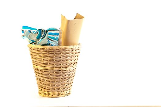 A waste paper bin on a white background