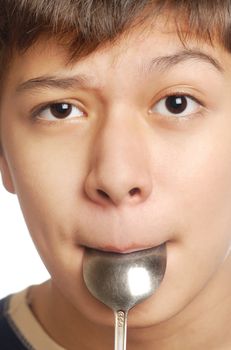 Studio photo of the hungry boy eating his spoon
