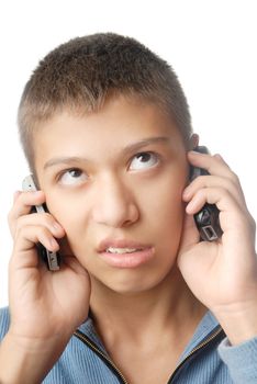 Boy with two cell phones on a white background