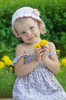 Coquettish little girl portrait with yellow flowers