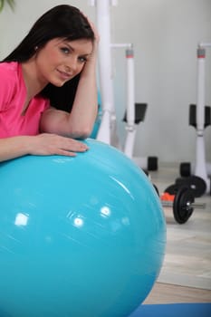 Woman leaning on gym ball