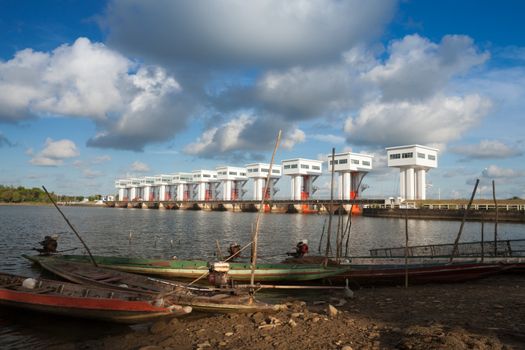 Traditional fishing boats parked along the waterfront near the floodgates.