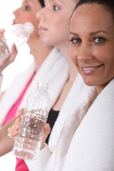 Sportswomen hydrating after effort