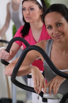 Women using exercise equipment in a gym