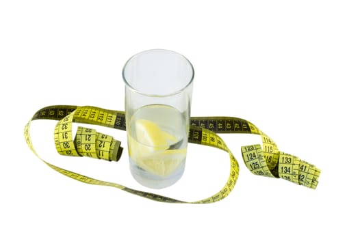 spring water with lemon and a glass of yellow centimeter around the glass isolated on white background