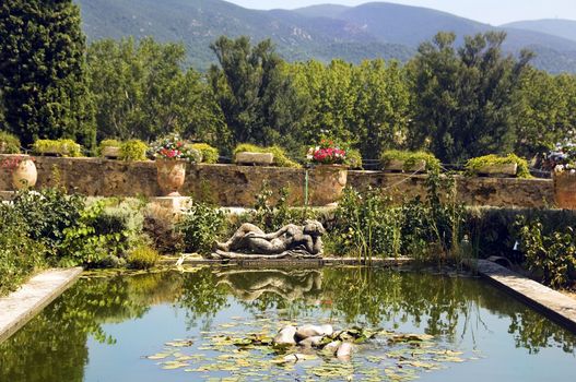 statue of a woman dozing on the banks of a picturesque pond in the Lourmarin Castle ( chateau de lourmarin ), Provence, Luberon, France