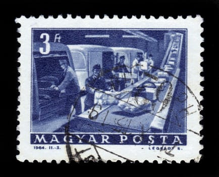 HUNGARY - CIRCA 1963:A stamp printed in Hungary shows postal employees and the conveyor to parcels, circa 1963.