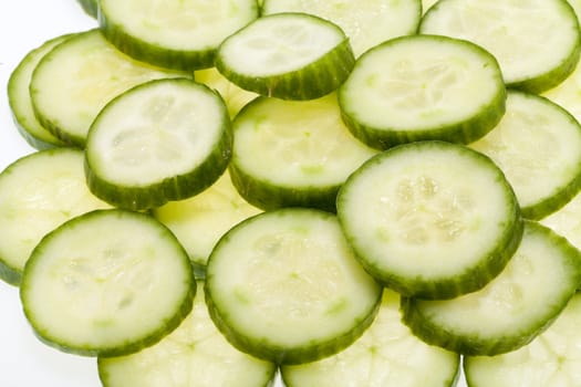 Freshly sliced cucumber  isolated on white background 