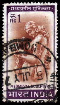INDIA - CIRCA 1965: A stamp printed in India shows image of a medieval sculpture from the Parshwanath Jain Temple of Khajuraho, circa 1965