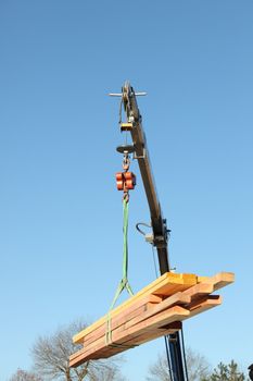 Crane lifting timber