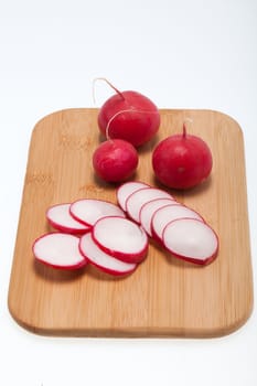 Garden radish on wooden board 