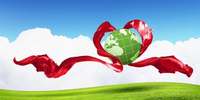 World within the heart symbol on blue sky background