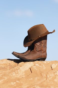 brown cowboy hat and boots outdoor