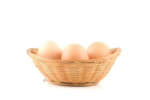 eggs in a wicker basket on white background