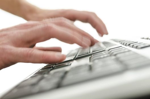 Closeup of a blurred hands typing on computer keyboard.
