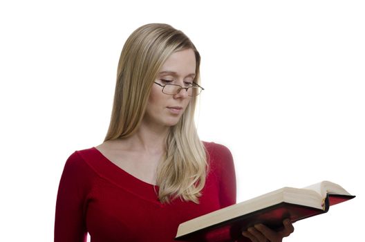portrait of a young woman with glasses reading a book isolated on white background