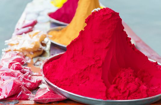 Piles and mounds of Indian colorful dye powders for holy festival and religious purposes at open market. 