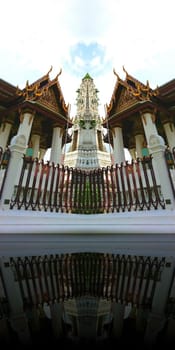 Thai temple with symmetrical reflection