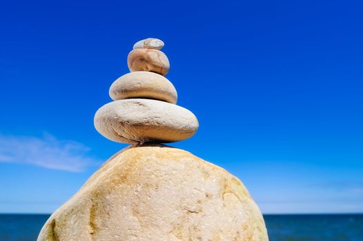 Pile of the yellow pebble on background the blue sky