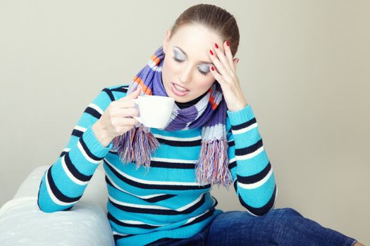 Sick woman with headache and high temperature holding cup with drug