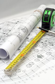 detail of an engineer workplace table with plans on paper and instruments