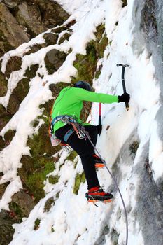 mountaineer beginning the ascent on a big wall in winter