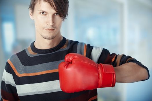 Man at the office with boxing glove. Horizontal photo