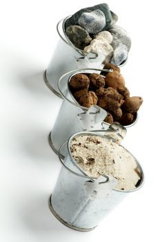 Three Tin Buckets with Gravel, Sand and Stones in a Row isolated on white background