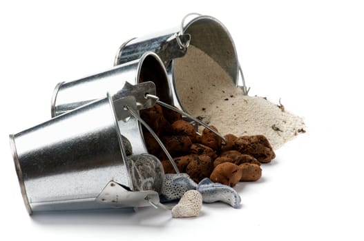 Tin Buckets with Spilled Gravel, Sand and Stones in a Row isolated on white background